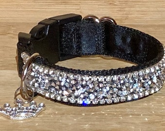 May include: Black dog collar with a silver rhinestone trim and a silver crown charm.