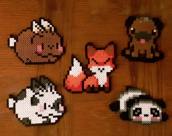 May include: Five colorful pixel art animal figures made with beads. The figures are a brown pig, a red fox, a black and white cat, a brown pug, and a black and white panda.