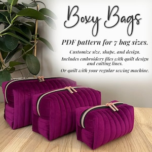 May include: Three quilted, plum-colored cosmetic bags with gold zippers and pulls. The bags are in different sizes, arranged from largest to smallest. Text at the top reads "Boxy Bags" and describes the pattern for 7 bag sizes.