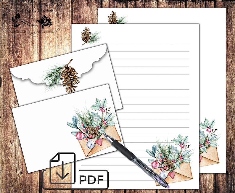 May include: Printable stationery set with a winter theme. The design features envelopes with watercolor illustrations of pine branches, holly, pine cones, and ornaments. The paper has lined writing space.