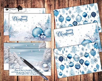 May include: A collection of Christmas cards and envelopes with winter-themed designs. The cards feature blue ornaments, snowy landscapes, and the text "merry Christmas." The envelopes have a matching pattern of ornaments and trees.