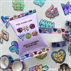 May include: A package of purple foil washi tape with the text "YEHETMONKEY" and "MULTI TAGGING KAWAII VER." printed on it. The tape features colorful graphic designs and logos. Additional rolls of washi tape and stickers are scattered around the package.
