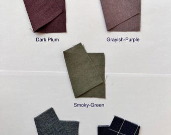 May include: A collection of fabric swatches in various colors. The swatches include Dark Plum, Grayish-Purple, Smoky-Green, Blue Melange, and Navy-Blue Check. Each swatch is labeled with its respective color name.