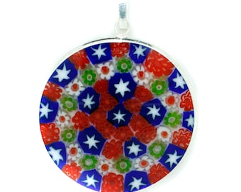 May include: Round pendant with a silver bail, featuring a colorful mosaic design. The mosaic incorporates red, white, blue, and green floral and star patterns. The pendant has a polished silver border and is set against a white background.
