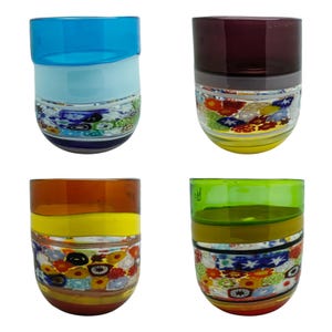 Puede incluir: Cuatro vasos de vidrio coloridos. Cada vaso presenta un diseño único con bandas de color y un patrón floral decorativo. Los colores incluyen azul, morado, naranja y verde. Estos vasos hechos a mano añaden un toque artístico a cualquier mesa.