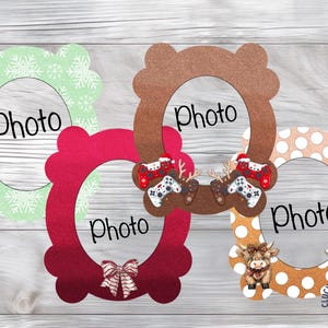 May include: Four decorative oval photo frames with scalloped edges. One is light green with white snowflakes, one is dark red with a bow, one is brown with gaming controllers, and one is orange with white polka dots and two highland cows.
