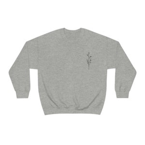 May include: A heather gray sweatshirt with a small black line drawing of a flower on the left chest.