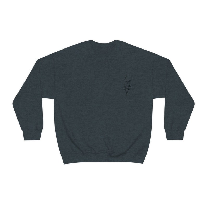 May include: A dark heather grey sweatshirt with a small black floral design on the left chest.