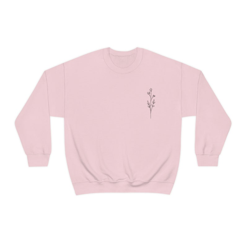 May include: A pink sweatshirt with a small floral design on the left chest.