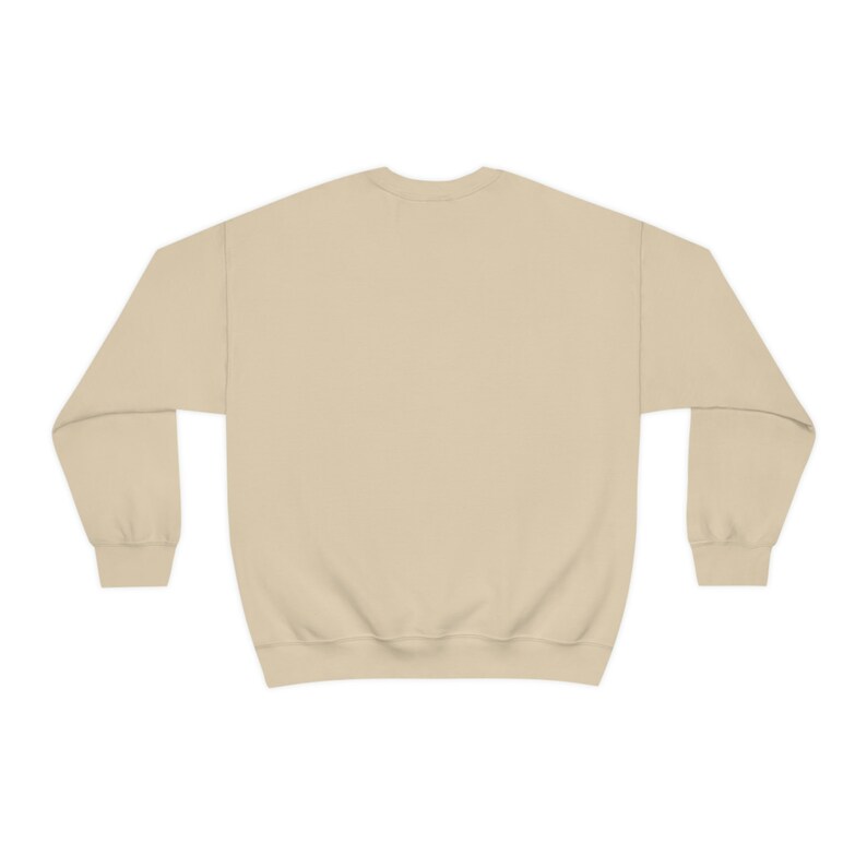 May include: A plain, light beige sweatshirt with long sleeves and a crew neck.