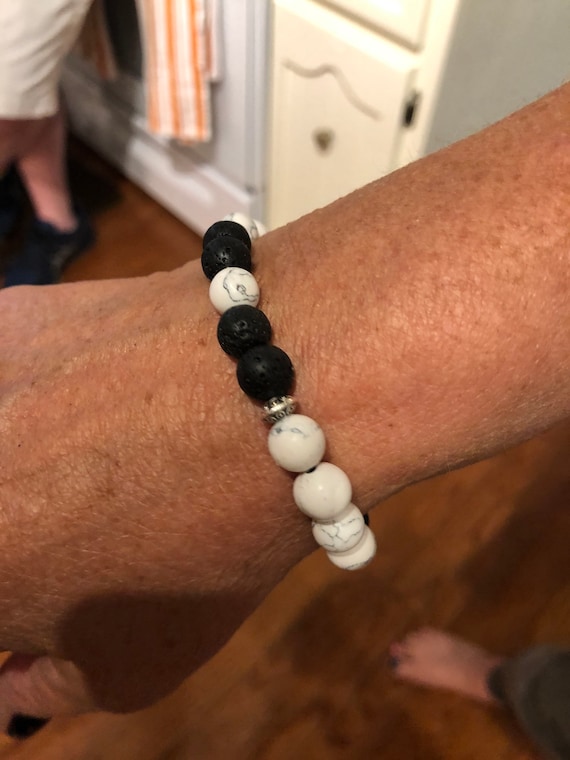 Black bead bracelet with cheap one white bead