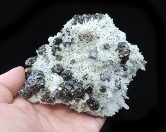 Large block covered with small terminated quartz crystals hosting cubes of galena and cleiophane sphalerite with a dusting of chalcopyrite