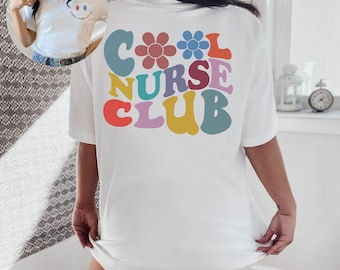 May include: A white short-sleeve t-shirt featuring the text COOL NURSE CLUB in large, colorful, wavy letters on the back, accented by two flower icons. A smaller version of the design is printed on the front left chest area of the garment.