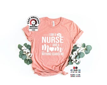 May include: A peach-colored short-sleeve t-shirt featuring white text that reads I AM A NURSE AND A MOM NOTHING SCARES ME, with a small nurse cap icon above the word NURSE and a heart shape replacing the letter O in the word MOM.