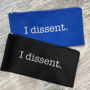 May include: Two zippered pouches, one black and one blue, with the text "I dissent." printed in white on each.