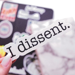 May include: White sticker with black text that reads "I dissent."
