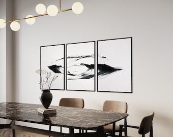 May include: A triptych of three rectangular wall art prints featuring abstract black ink brush strokes on a white background, each enclosed in a thin black frame. The artwork is displayed horizontally in a row on a plain light-colored wall.