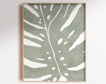 May include: A digital print of a green and white monstera leaf in a wooden frame. The leaf is stylized with a white outline and a textured background.