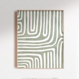 Op de afbeelding: Een ingelijst abstract print met een geometrisch patroon in groen en wit. Het patroon bevat gebogen lijnen en vormen.