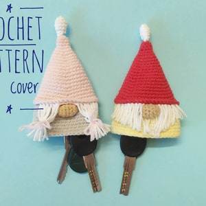 May include: Two crocheted gnome key covers, one pink and one red, with white beards and yellow hats. The text "CROCHET PATTERN key cover" is visible at the top of the image.