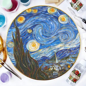May include: A round, gold-rimmed plate with a blue and yellow painting of Van Gogh's Starry Night. The plate is surrounded by various craft supplies, including paint bottles, a paintbrush, and a bottle of glue.