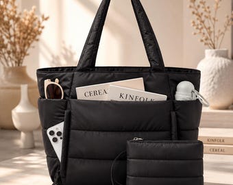 May include: A black quilted tote bag with two top handles and a matching zippered pouch. The bag features exterior side pockets containing a white smartphone, sunglasses, and a small umbrella, with two books labelled CEREAL and KINFOLK inside.