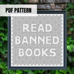 May include: A framed cross-stitch pattern with the words "READ BANNED BOOKS" in bold white letters. The background features a detailed, repeating geometric design. The phrase "PDF PATTERN" is in the upper left corner.