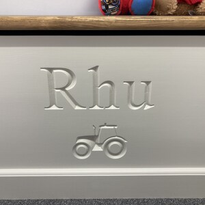 May include: White wooden toy box with the name "Rhu" carved into the front, along with a small tractor design.