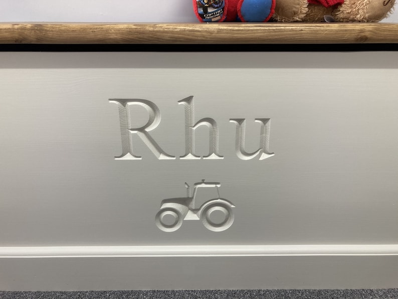 May include: White wooden toy box with the name "Rhu" carved into the front, along with a small tractor design.