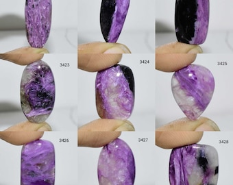 May include: Nine purple and black cabochon gemstones with a shimmering, iridescent finish. Each stone is labelled with a number from 3420 to 3428.