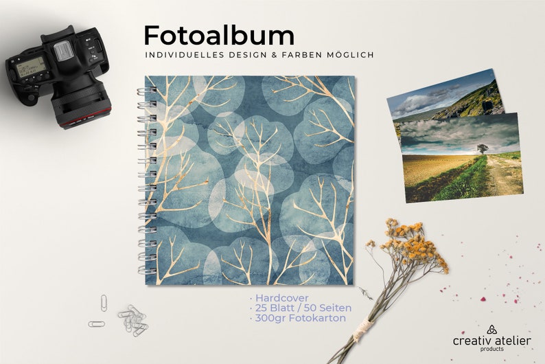May include: A blue photo album with a white and gold leaf pattern. The album has a hardcover, 25 sheets, 50 pages, and is made with 300gsm photo paper. The text "Fotoalbum" and "INDIVIDUELLES DESIGN & FARBEN M&Ouml;GLICH" is printed on the top of the image.