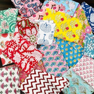 May include: A collection of colorful fabric squares with various floral and geometric patterns. The fabrics are made of cotton and are perfect for quilting, sewing, or crafting.