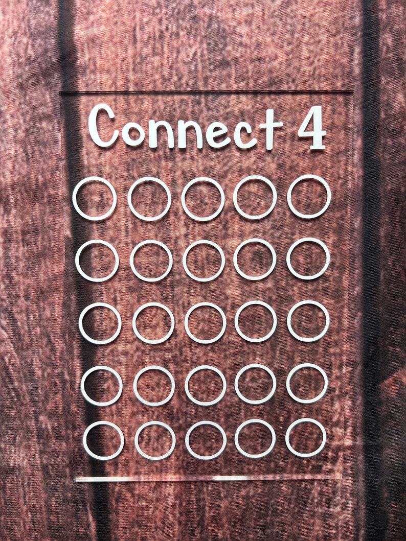 May include: A white Connect 4 game board with 7 columns and 5 rows of empty circles.