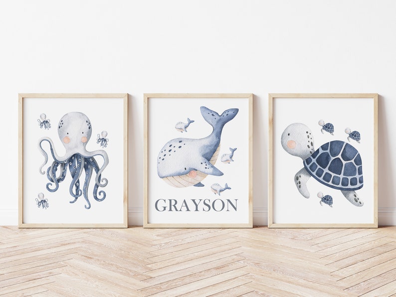 May include: Three watercolor prints featuring a blue octopus, a whale, and a turtle. The whale print includes the name Grayson.
