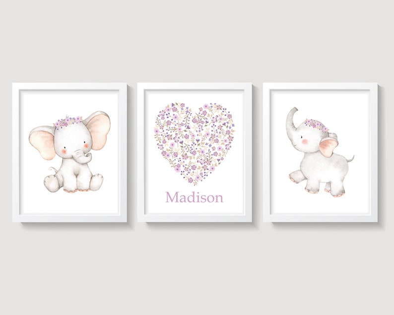 May include: Three framed prints featuring a cute elephant with a purple flower crown. The middle print has a heart shape made of purple flowers and the name "Madison" written below it.