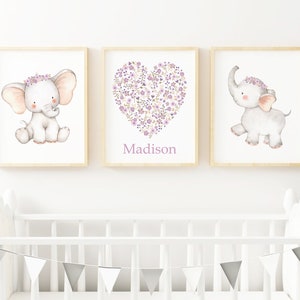 May include: Three framed prints with a watercolor illustration of a cute elephant with a purple flower crown. The middle print features a heart shape made of purple flowers with the name "Madison" written below.