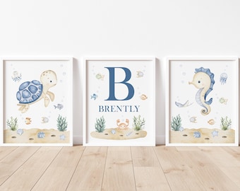 May include: Three framed watercolor prints with an ocean theme. One features a turtle, another a seahorse, and the third a large blue letter "B" with the name "Brently". Each print has sea creatures and plants.