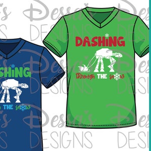 May include: Two t-shirts with a Christmas-themed design featuring a white AT-AT walker pulling a sleigh. The text on the shirts reads "Dashing through the snow". The shirts are blue and green.