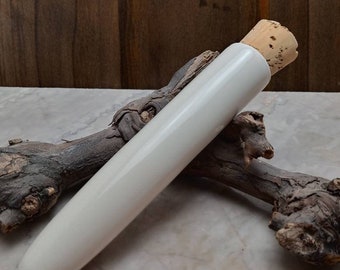 Porcelain dube tube with cork stopper.