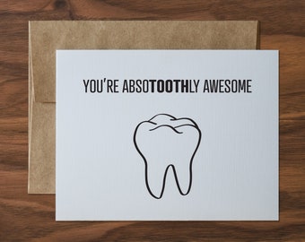 May include: A white card with the text "You're Absotoothly Awesome" and a black and white illustration of a tooth.