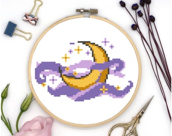 May include: A yellow crescent moon with purple clouds and white stars in a wooden embroidery hoop.