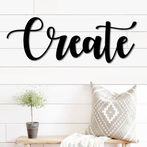 May include: Black metal wall decor with the word "Create" in a cursive font.