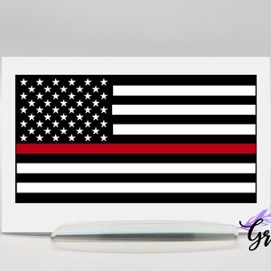 May include: A black and white American flag with a single red stripe across the middle. The flag is printed on a white background.