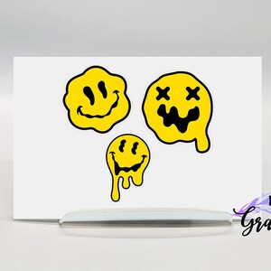 May include: Three yellow smiley face stickers with black outlines. The top two stickers have dripping edges. The top left sticker has a regular smiley face. The top right sticker has an X for eyes and a wide smile. The bottom sticker has a regular smiley face and dripping edges.