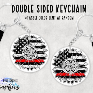 May include: Double-sided keychain featuring a black and white sunflower with a red line across the center, representing the thin red line. The sunflower is made up of an American flag and a thin red line flag. The keychain is attached to a silver chain with a black tassel.