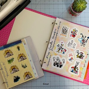 May include: A pink binder with a white interior and a clear plastic sleeve containing stickers. The stickers feature a mountain range with a sunflower and a forest scene. The binder also contains a page of colorful cartoon stickers with the text "Pony Express Graphics -  Ponyexpressgraphics.etsy.com".