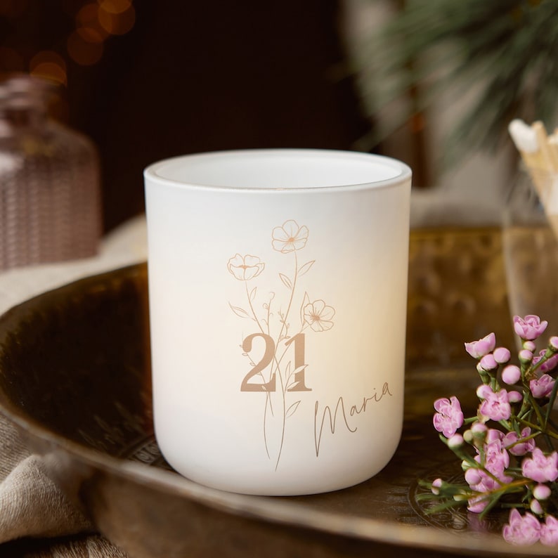 May include: White candle holder with a floral design and the number 21 and the name Maria printed in brown.