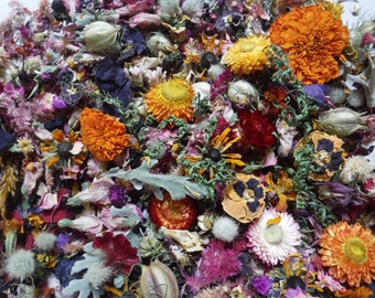 May include: A mix of dried flowers and petals in various colors, including orange, yellow, pink, purple, and red. The flowers are arranged in a random pattern and create a colorful and vibrant display.