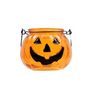 May include: Orange glass pumpkin with a black jack-o'-lantern face and a black wire handle.