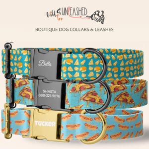 May include: Three dog collars with custom buckles. The top collar is teal with cheese wedges and a black buckle engraved with Bella. The middle collar is light blue with pizza slices and a black buckle engraved with Shasta and 888-321-9876. The bottom collar is light blue with hot dogs and a gold buckle engraved with Tucker.